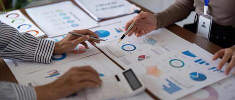 Business team collaborating on financial analysis with charts and graphs during a strategy meeting photo