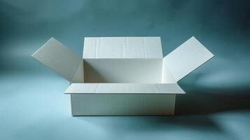 A white cardboard box with its flaps open, sitting on a light blue background photo
