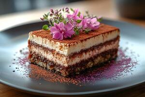 Gourmet Tiramisu Slice with Cocoa and Floral Garnish for Dessert Presentation photo