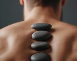 Calm and peaceful spa treatment featuring smooth stones on back photo