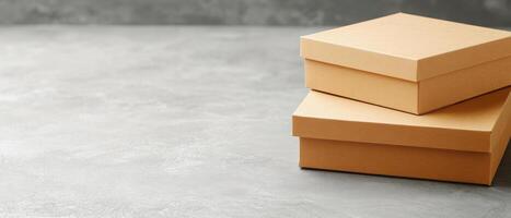 Minimalist kraft paper boxes stacked on textured gray surface, showcasing simplicity and elegance. Perfect for packaging or storage solutions photo