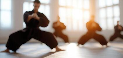 Training in dojo, martial artists practice their skills in black uniforms, focusing on technique and discipline. warm light creates inspiring atmosphere for their training photo