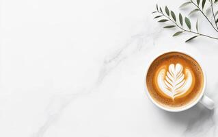 beautifully crafted coffee latte art featuring leaf design, placed on marble surface with greenery. This evokes sense of calm and sophistication photo