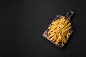 Delicious crispy French fries with salt and spices d photo