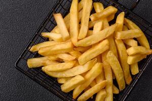 Delicious crispy French fries with salt and spices or photo