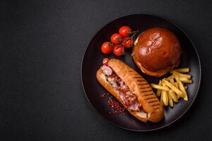 Delicious juicy hot dog with sausage, bacon, sauce, salt and spices j photo
