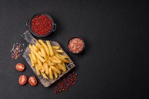 Delicious crispy French fries with salt and spices p photo