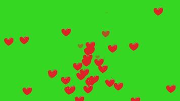 Red hearts are scattered across a bright green background, some appearing to fall or floa video