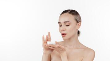 A close-up shot of a woman with glowing skin and natural makeup in a studio setting. Perfect for promoting face care products, moisturizing creams, and skincare routines, this high-quality image photo