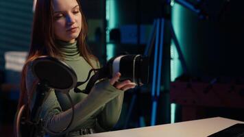 Tech specialist filming sponsored content, unboxing newly released VR glasses product to make fans buy it. Entertainer amazed by product, presenting virtual reality headset to subscribers, camera A video