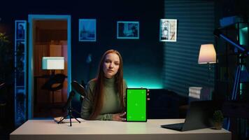 Tech guru excited to review newly released mockup tablet, comparing features with older models. Influencer filming for social media, analyzing latest generation of green screen device, camera B video