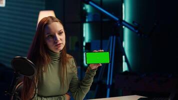 Smiling tech expert reviews newly released mockup green screen smartphone, comparing features with older models. Upbeat influencer analyzing latest generation of chroma key mobile phone video