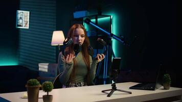 Young content creator films review of book, browsing through pages, presenting synopsis to audience. Internet star sponsored by publisher to show new novel release to readers, camera B video