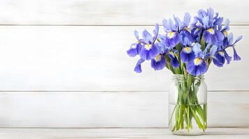 bouquet of blue irises in clear vase on wooden background, adding touch of elegance and freshness to any space photo