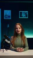 Vertical Social media star uses professional gear to capture welcoming intro for vlogging channel, interacting with online community. Influencer connects with loyal fanbase during live stream, camera B closeup video