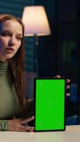 Vertical Tech guru excited to review newly released mockup tablet, comparing features with older models. Influencer filming for social media, analyzing latest generation of green screen device, camera A video
