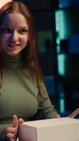 Vertical Content creator filming technology review of various electronics, unboxing them and presenting features to audience. Influencer showing product recommendations to followers on social media, camera A video