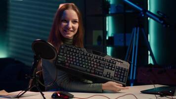 Happy influencer testing keyboard and mouse while doing review in personal studio to see if price is justified. Cheerful media star showcasing computer peripherals features to audience, camera A video