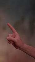 A Hand Pointing Gesture Set Against a Softly Blurred Background to Create Depth and Focus video