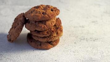 Stack of cookies rotate on gray cement background. Cookie with chocolate, copy space for text. video