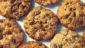 Top view of cookies rotate on gray cement background. Cookies with chocolate, copy space for text video