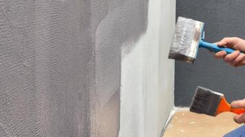 A person skillfully applies paint to a slow quartz wall, focusing on details and ensuring a smooth finish video