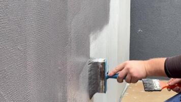 A worker is expertly applying a smooth finish to a quartz wall during a home renovation. The process highlights precision and care in wall preparation video