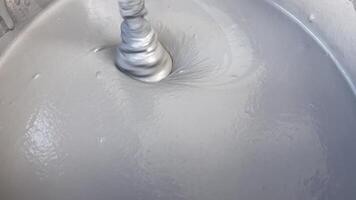 The mixing process of slow cure quartz wall material, focusing on achieving a smooth, consistent texture ideal for interior applications video