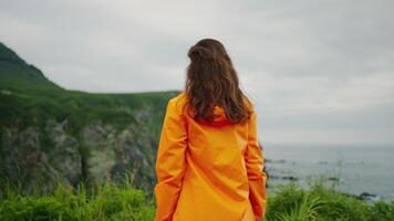 Solitude And Unity With Nature, Back View Of Woman Waking On Edge Of Cape On Ocean Coast video