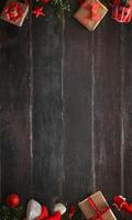 Vertical rustic dark wooden table with a black-brown texture, gifts arranged at the top and bottom, featuring a central empty space for text photo