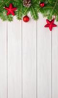 Top view flat lay of a white table with Christmas tree decorations, wooden ornaments, and a pinecone, featuring central empty space for promo text photo