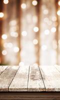 White rustic table with bokeh Christmas lights in the background, front view, providing an empty surface ideal for product promotions and festive campaigns photo
