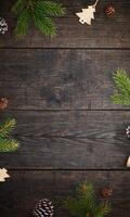 Rustic wooden table with Christmas branches and decorations, top view flat lay, featuring an empty space for a holiday greeting or festive message photo