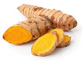 Bright orange turmeric root with slices showcasing vibrant color and texture photo
