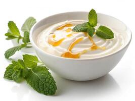 Creamy white yogurt topped with honey and fresh mint leaves photo