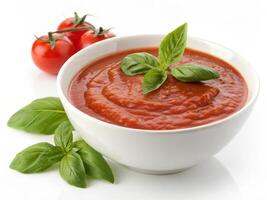 Fresh red tomato sauce garnished with basil leaves in bowl photo