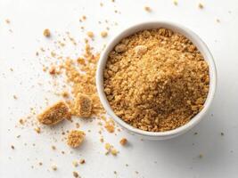High resolution image of golden brown breadcrumb in bowl, scattered around photo