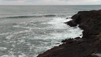 Ocean Waves And Clouds With Boat In Background And Volcanic Rock Shore Depoe Bay Oregon video