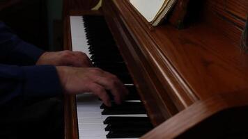 Side Shot Of Older Man's Hands Playing On Upright Piano video