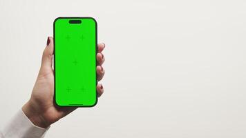 Hand Holding Smartphone with Green Screen on White Background video