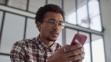 Man reading negative response on smartphone video