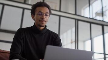 Man speaking during a call using laptop in office video