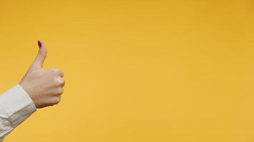 Thumbs up gesture on yellow background video