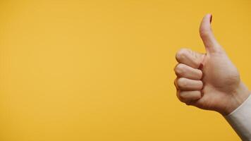 Thumbs-up gesture on yellow background video