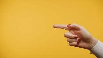 Hand pointing at Copy Space on a yellow background video