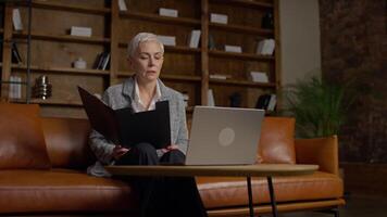 Senior woman discussing a report during call video