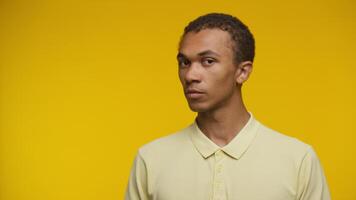 Smiling man looking directly at camera with copy space on yellow video