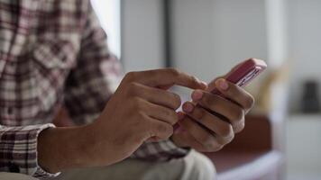 Close-up of hands scrolling on smartphone video
