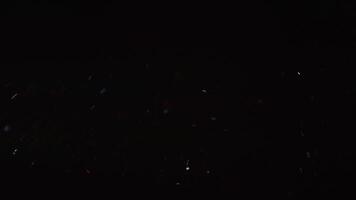 Realistic dust particles in space on a dark background. Black isolated background, light on a black background. Abstract white and luminous dust particles on a black background video