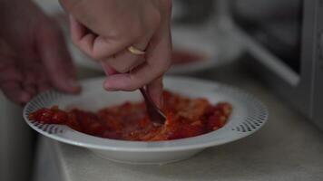 The plate slips out of my hands. Berry dessert on a plate. Strawberries with sugar. A man's hand kneads strawberries with a fork in a plate video